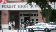 Marion County Police officers walk out Forest High School after a school shooting on April 20, 2018 in Ocala, Florida. It was reported that a former student shot a 17-year-old male student in the ankle The shooter, whose name has not yet been released, is