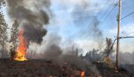 This image released by the US Geological Survey shows lava from a fissure slowly advancing to the northeast on Hookapu Street in Leilani Estates, Hawaii, on May 5, 2018. AFP PHOTO / US Geological Survey/HO