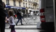 A bullet hole, seen on the window of a cafe located at the crossroads between the streets Saint-Augustin and Monsigny, is pictured on May 13, 2018 in Paris, the day after a knifeman killed one man and wounded four other people.  AFP / Eric FEFERBERG
