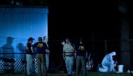 Investigators work outside a trailer near Santa Fe High School following a mass shooting May 18, 2018 in Santa Fe, Texas. / AFP / Brendan Smialowski 