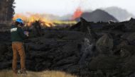 A USGS (US Geological Survey) geologist inspects a recent Lava flow from a Kilauea volcano fissure on Hawaii's Big Island on May 19, 2018 in Kapoho, Hawaii. Mario Tama/Getty Images/AFP