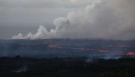 Lava from a Kilauea volcano fissure (C) flows toward the ocean on Hawaii's Big Island on May 20, 2018 in Kapoho, Hawaii.  Mario Tama/Getty Images/AFP