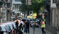 Police and ambulance are seen at the site where an armed man shot and killed police officers before being subdued by police in the eastern Belgian city of Liege on May 29, 2018. / AFP / JOHN THYS