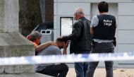 A man is being consoled on the scene of a shooting in Liege, Belgium, May 29, 2018. REUTERS/Francois Lenoir