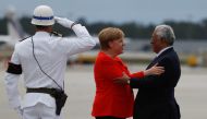 German Chancellor Angela Merkel greets Portuguese Prime Minister Antonio Costa during a welcoming ceremony at the start of a two-day official visit in Porto, Portugal, May 30, 2018. REUTERS/Pedro Nunes