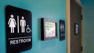 Unisex signs hanging outside bathrooms at Toast Paninoteca in Durham, North Carolina, May 9, 2016.  AFP/  Getty Images North America / Sara D Davis