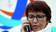 Christiane Lambert, President of France's farmer's union group FNSEA, makes a phone call as she stands in front journalists during a protest by French farmers near the French oil giant Total refinery in Donges, France, June 11, 2018. Reuters/Stephane Mahe
