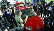 In this file photo taken on June 8, 2005, Mahathir Mohamad gives a thumbs-up sign during the launch of the Proton Savvy, the national carmaker's new model in Kuala Lumpur.  AFP / Tengku Bahar