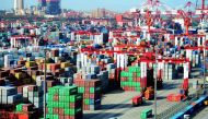 (FILES) This file picture taken on April 13, 2018 shows shipping containers transferred at a port in Qingdao, in China's eastern Shandong province. China OUT / AFP /
