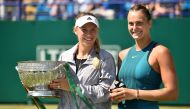 Denmark's Caroline Wozniacki holds the winner's trophy (L) alongside Belarus's Aryna Sabalenk aafter their Women's singles finals match at the ATP Nature Valley International tennis tournament in Eastbourne, southern England on June 30, 2018.  AFP / Glyn 