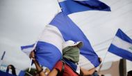 Demonstrators hold Nicaraguan national flags during a protest against President Daniel Ortega's government in Managua, Nicaragua, July 3, 2018. REUTERS/Jorge Cabrera
