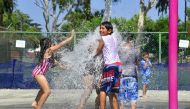 Children cool off on a hot summer day at a water park in Alhambra, California on July 3, 2018 as southern California braces for a coming heatwave with temperatures expected to hit triple digits. / AFP / Frederic J. BROWN 