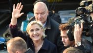 In this file photo taken on May 04, 2017 then French presidential election candidate for the far-right Front National (FN) party, Marine Le Pen (C), followed by her bodyguard Thierry Legier (up), waves before a meeting in Ennemain, northern France. AFP / 