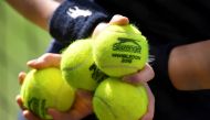 A ball boy holds balls during Reuters/Toby Melville