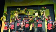 Australia's Richie Porte (C) and his teammates of USA's BMC Racing cycling team celebrate on the podium after winning the third stage of the 105th edition of the Tour de France cycling race, a 35.5 km team time-trial around Cholet, western France, on July
