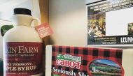 A Vermont airport is displaying 7-foot-tall maple syrup jugs to remind travellers they can buy the state staple online instead of losing it at security when their liquids get confiscated. (Photo courtesy:  Dakin Farm via Instagram)