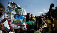 Supporters of the ruling ZANU-PF party of President Emmerson Mnangagwa celebrate following general elections in Harare, Zimbabwe, July 31, 2018. (REUTERS/Philimon Bulawayo)