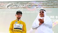 FILE PHOTO: British rider Mark Cavendish (L) of the Dimension Data team celebrates on the podium wearing the overall leader's golden jersey next to Sheikh Khalid Bin Ali Al Thani (R), President of the Qatar Cycling Federation (QCF), after winning the firs