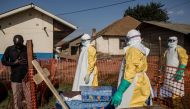 A family member of a deceased, unconfirmed Ebola patient, reacts inside an Ebola Treatment Centre run by The Alliance for International Medical Action (ALIMA) on August 13, 2018, in Beni. AFP / John Wessels 