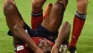 Bayern Munich's German forward Thomas Mueller checks on his injured teammate French forward Kingsley Coman during the German first division Bundesliga football match FC Bayern Munich v TSG 1899 Hoffenheim at the Allianz Arena in Munich, southern Germany o