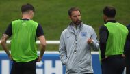 England's manager Gareth Southgate (C) talks to England's defender John Stones (L) and England's defender Kyle Walker during an open training session at St George's Park in Burton-on-Trent, central England on September 4, 2018, ahead of their internationa