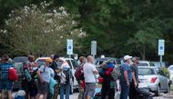 People line up to enter a hurricane shelter at Trask Middle School in North Carolina on September 11, 2018. AFP / Andrew Caballero-Reynolds 