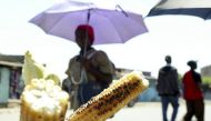 A woman walks past roasted corn for sale in Kenyan capital Nairobi, July 14, 2009. (Reuters/Noor Khamis) 