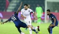 Al Sadd’s Xavi Hernandez (centre) weaves his way past a couple of Al Rayyan players during the QNB Stars League match in Doha yesterday.
