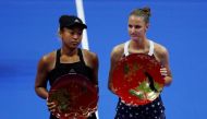 Karolina Pliskova (R) of Czech Republic, flanked by second-placed Naomi Osaka of Japan, poses with her victory trophy. REUTERS/Toru Hanai
