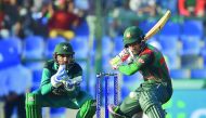 Bangladesh batsman Mushfiqur Rahim plays a shot as Pakistan captain and wicketkeeper Sarfraz Ahmed (L) looks on during the one day international (ODI) Asia Cup cricket match between Bangladesh and Pakistan at the Sheikh Zayed Stadium in Abu Dhabi on Septe