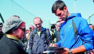 Serbia's tennis player Novak Djokovic signs an autograph after a training session in Belgrade on October 1, 2018. AFP / Pedja Milosavljevic
 
