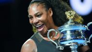 This file photo taken on January 28, 2017 shows Serena Williams of the US holding the winner's trophy following her victory over Venus Williams of the US in the women's singles final of the Australian Open tennis tournament in Melbourne.  AFP / Paul Crock