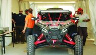 Drivers and mechanics are seen during the scrutineering process at the QMMF headquarters yesterday, on the eve of the third round of the Qatar Manateq Baja which will be held today. The ceremonial start will be held at 8.00am with the official start sched