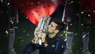 Serbia's Novak Djokovic kisses the trophy after winning his men's final singles match against Croatia's Borna Coric at the Shanghai Masters tennis tournament in Shanghai on October 14, 2018. / AFP / WANG Zhao