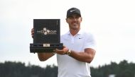 Brooks Koepka of the US poses with the trophy during the awards ceremony after winning the CJ Cup golf tournament at Nine Bridges golf club in Jeju Island on October 21, 2018. AFP / Jung Yeon-je