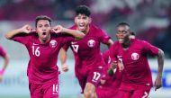 Qatar’s Hashim Ali (left) celebrates with team-mates after scoring against hosts Indonesia their AFC U-19 Championship match against hosts Indonesia at the Gelora Bung Karno Stadium in Jakarta yesterday.