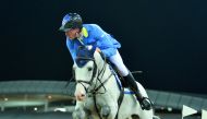 German rider Christian Ahlmann guides Caribis Z over an obstacle on his way to win the  Doha 2018 CSI5* 1.55m event during the final round of the Longines Global Champions Tour yesterday.