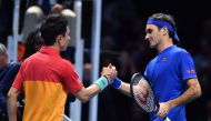 Japan's Kei Nishikori (L) greets Switzerland's Roger Federer after winning their singles round robin match 7-6, 6-3 on day one of the ATP World Tour Finals tennis tournament at the O2 Arena in London on November 11, 2018. AFP / Glyn Kirk