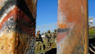 Agents with the U.S. Border Patrol Tactical Unit (BORTAC) stand guard behind the border fence between Mexico and the United States, as seen from Tijuana, Mexico November 14, 2018. REUTERS/Jorge Duenes