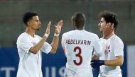 Qatar’s Akram Afif (left) celebrates with team-mates after scoring a goal against Switzerland during their international friendly in Lugano, Switzerland on Wednesday. 