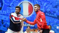 France's Jo-Wilfried Tsonga (L) and Croatia's Borna Coric shake hands next to the Davis Cup trophy on the eve of the Davis Cup tennis final between France and Croatia at the Pierre Mauroy Stadium in Villeneuve-d'Ascq, northern France, on November 22, 2018
