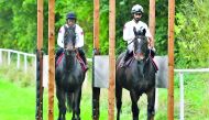 Qatari jockeys Abdulaziz Jaber Dharman and Saleh Salem Al Marri during a training session in this file picture. 