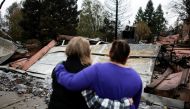 File photo of Irma Corona (R) comforts neighbor Gerryann Wulbern in front of the remains of Wulbern's home after the two returned for the first time since the Camp Fire in Paradise, California, U.S. November 22, 2018. REUTERS/Elijah Nouvelage