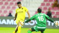 Al Sadd’s Baghdad Bounedjah (left) scores past Al Shahaniya goalkeeper A. Al Amri during their QNB Stars League match played at the Al Duhail Stadium yesterday.