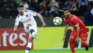 File photo of Al Sadd’s Baghdad Bounedjah (L) shoots at the goal during the AFC Champions League match against Persepolis at the Jassim bin Hamad Stadium in Doha.
