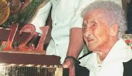 (FILES) In this file photo taken on February 21, 1996, Jeanne Calment, French pensioner and the world's oldest person, looks at her birthday cake upon turning 121 years old during a ceremony held in her honour at Arles City Hall in southern France. AFP / 