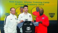Youssef Msakni (centre) poses with KAS Eupen coach Claude Makelele (right) and a club official at Aspire Academy in Doha, yesterday.    