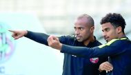 Qatar forward Akram Afif (right) and his team-mate Ali Hassan Afif during the training session, yesterday.   