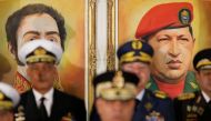 Portraits of Simon Bolivar and Venezuela's late President Hugo Chavez are seen during a news conference of Venezuela's Defense Minister Vladimir Padrino Lopez in Caracas, Venezuela January 24, 2019. Reuters/Manaure Quintero