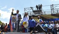 Opposition leader Juan Guaido (L) gestures next to his wife Fabiana Rosales as he delivers a speech before thousands of supporters, in Caracas on February 2, 2019. AFP / Juan Barreto 
